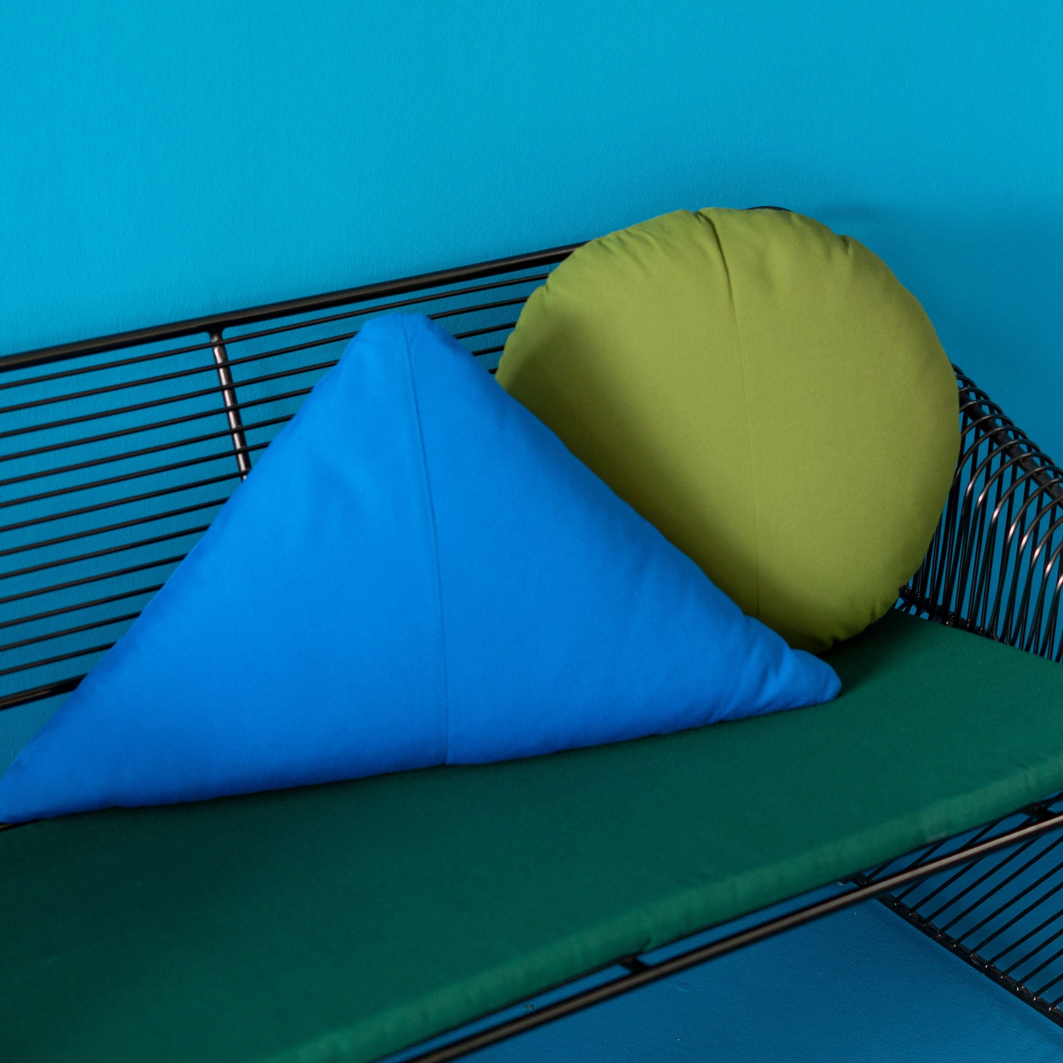 Bend Goods chair cushions are made from sunbrella fabric and work great for outdoor patio sets. Also available is leather and faux leather padding. Displayed in the image is our Blue and Green pad and throw pillow paired with a lounge chair.