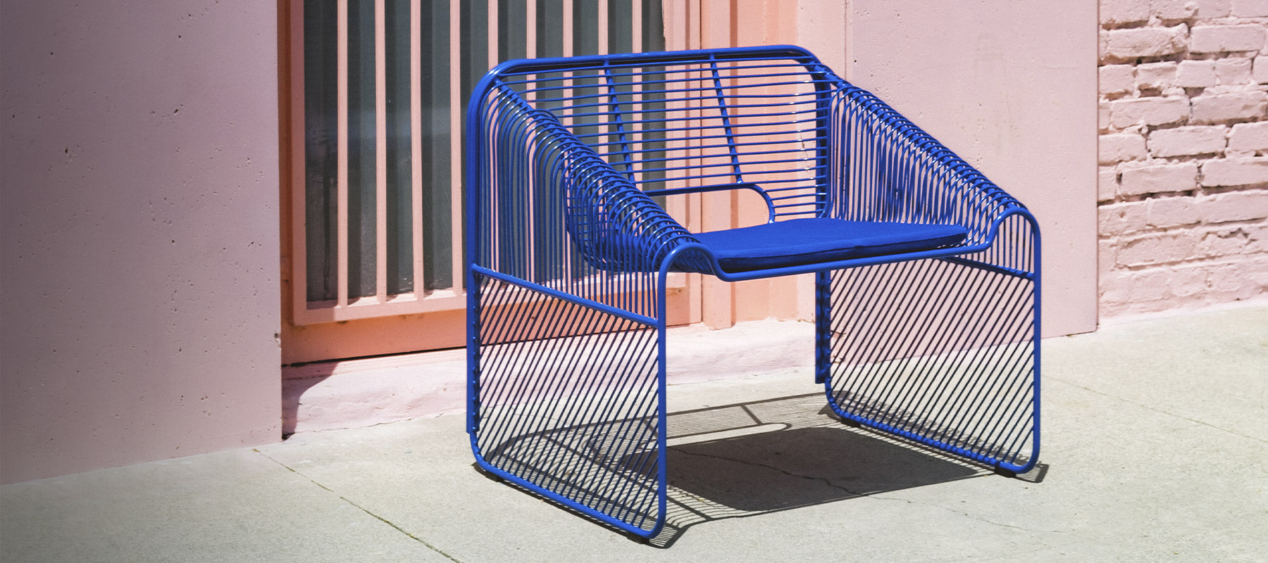 Hot Seat shown in Electric Blue in front of a pink wall