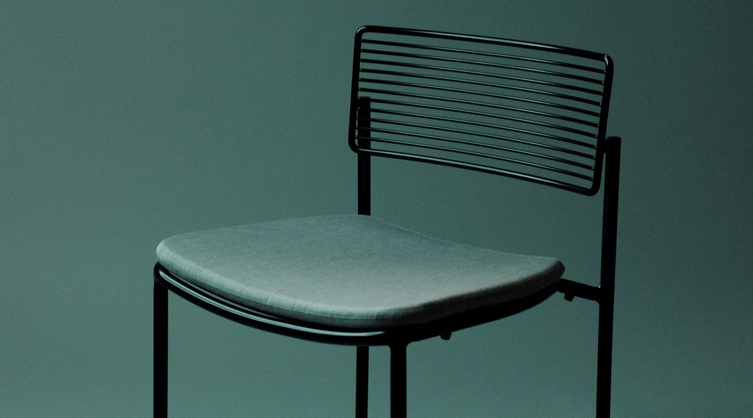 Close Up of Rachel Chair shown in Black with Granite Sunbrella Padding