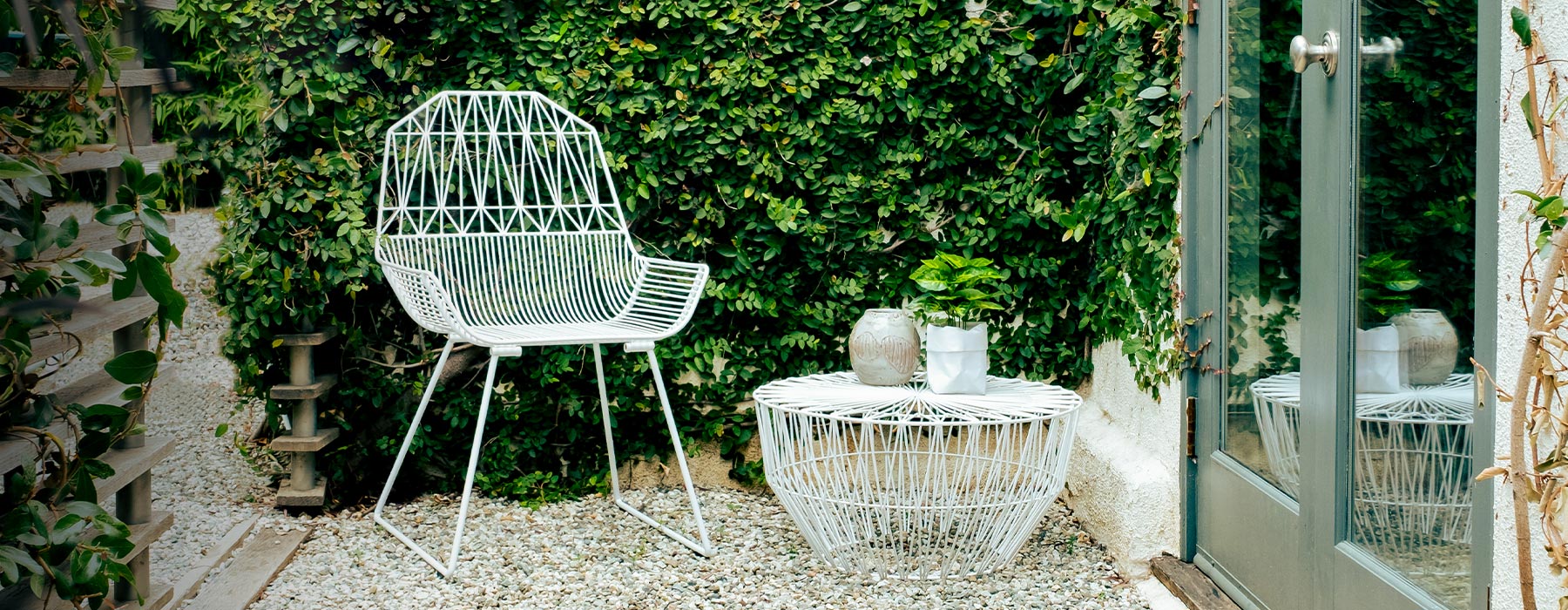 Farmhouse Lounge Chair shown in White. Pictured alongside Drum Table in White