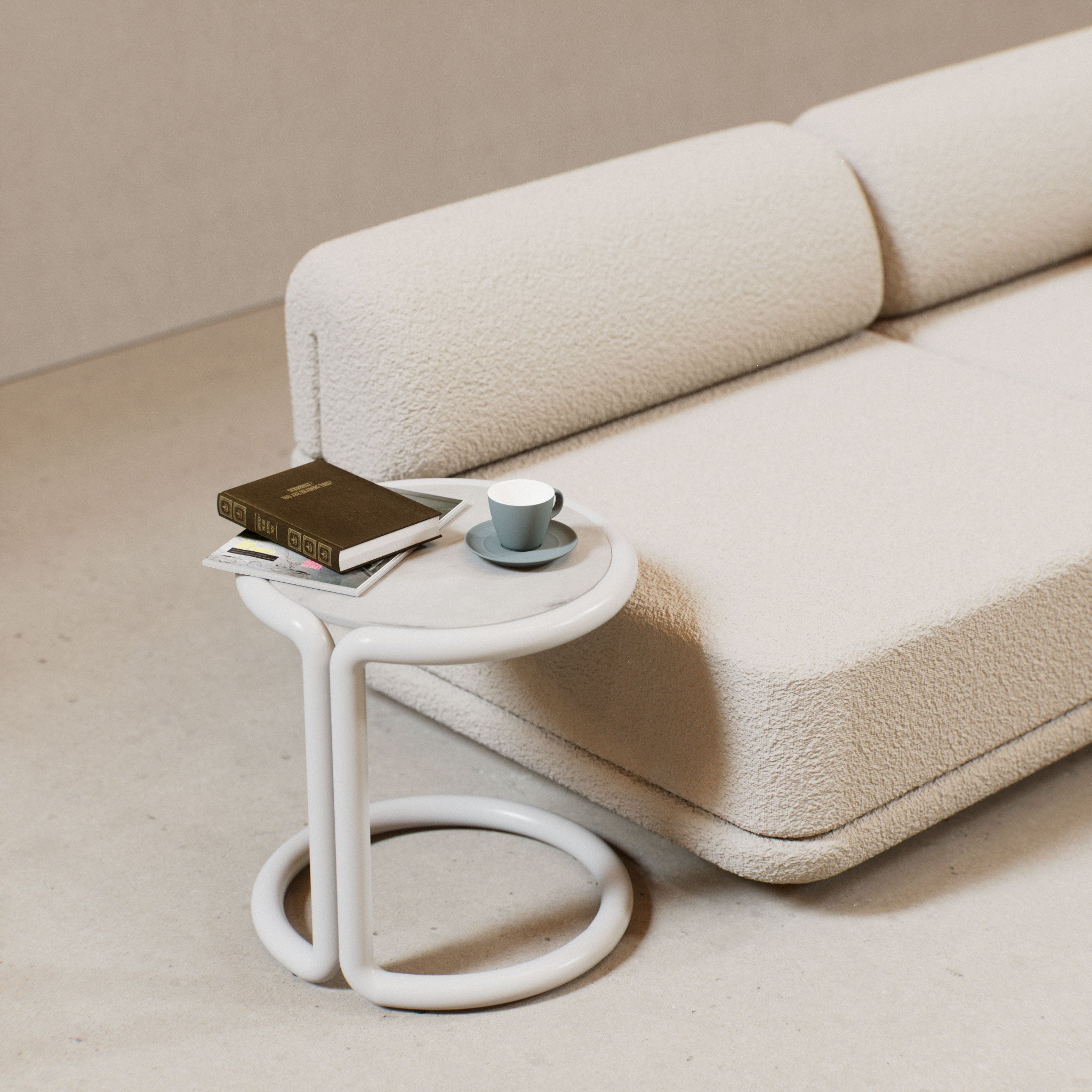 Bend Goods Tube Side Table is a Modern C-shaped side table with round stone top, sleek design for sofas, chairs, or chaises in living rooms or patios
