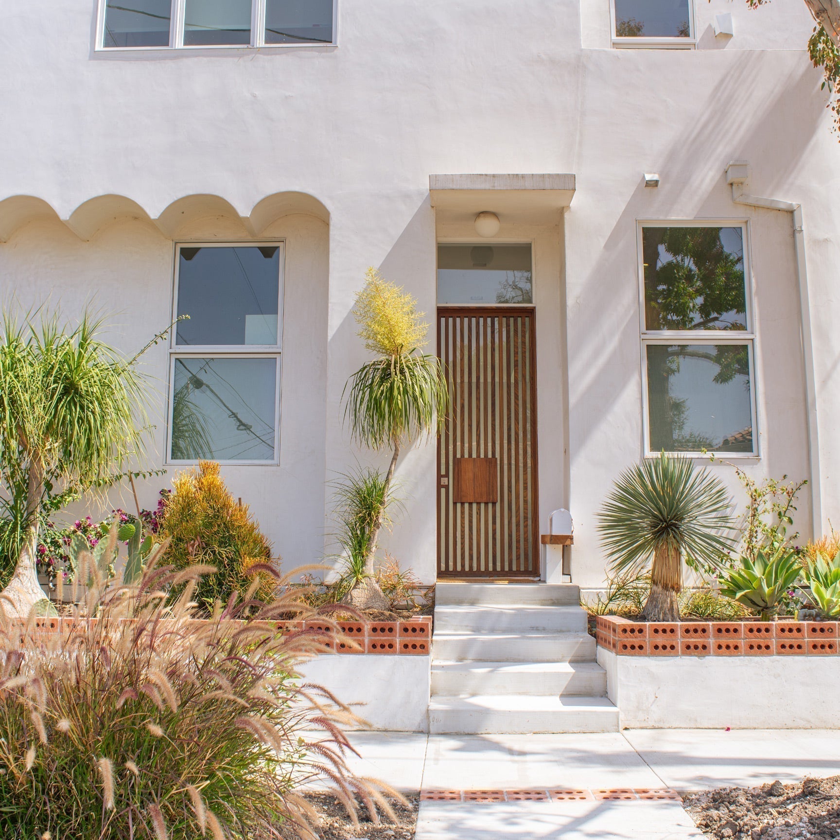modern Spanish home entryway with plaster walls and warm wood accents