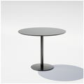 Black pedestal table with a round top, central column and circular base, three-quarter view.