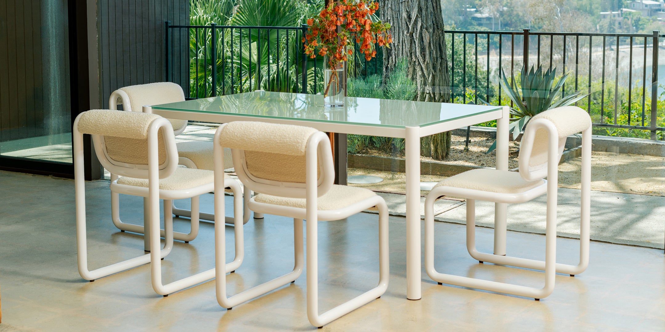 Tube Dining Chair shown in White with Cream Boucle along side the Get-Together Table