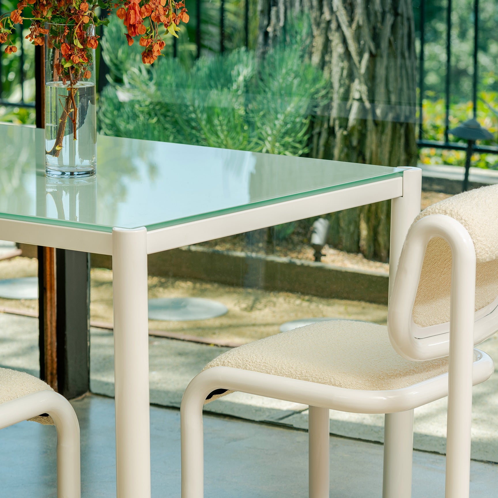 Close up on Get-Together Table shown in White. Pictured next to the Tube Dining Chair.