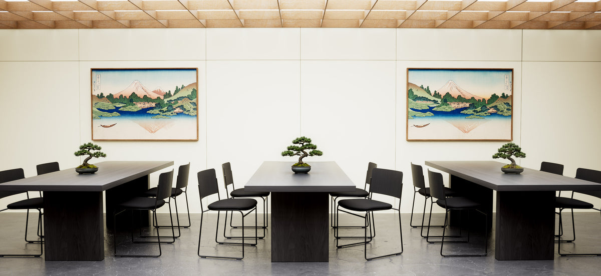 Three Black Wood Hinoki dining tables with black chairs and bonsai plants in a room with framed landscape art.
