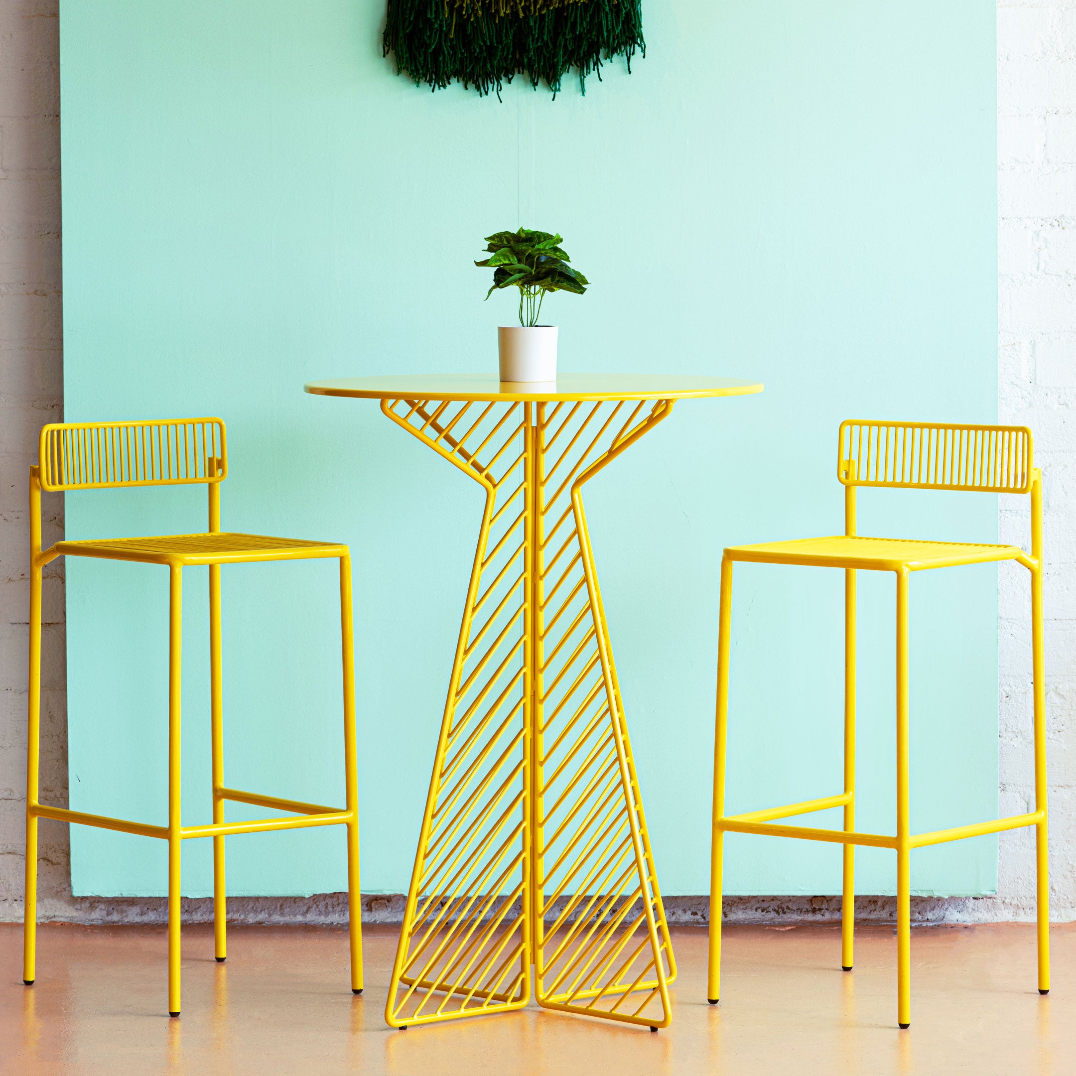 Rachel Barstools shown in Yellow with a Cafe Bar Table in the middle in Yellow as well.